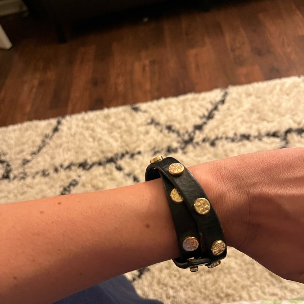 Tory Burch black wrap bracelet with gold pendants. Adjustable